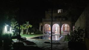 a night view of a house with a swimming pool at Ouirgane House in Ouirgane