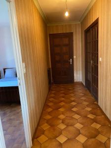 a hallway with a room with a door and a floor at Chambre HABILIS 31 in Auterive