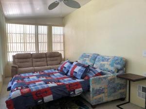 a bedroom with a bed and a couch at Paradise Found-Key Largo Kampground Divers Welcome in Key Largo
