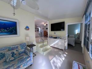 a living room with a couch and a flat screen tv at Paradise Found-Key Largo Kampground Divers Welcome in Key Largo