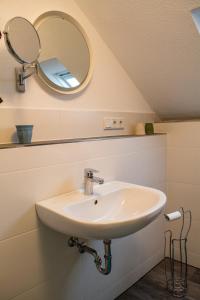 a bathroom with a sink and a mirror at Eulennest-OWL in Bad Salzuflen