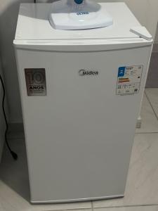 a white refrigerator with a counter on top of it at NOVO Ap Econômico em Paranaguá Completo com WiFi e Estacionamento Rotativo in Paranaguá