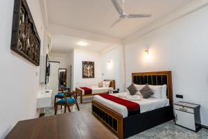 a hotel room with a bed and a desk at Golden stars hotel Dambulla in Dambulla