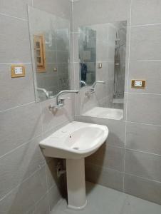 a bathroom with a sink and a shower and a mirror at Marwan Farmhouse Rooftop Apartment in Faraj Māḑī