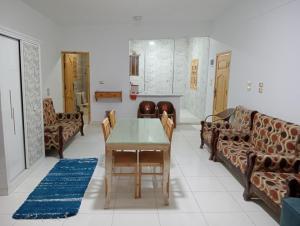 a living room with couches and a table at Marwan Farmhouse Rooftop Apartment in Faraj Māḑī