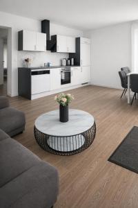 a living room with a coffee table and a kitchen at 3 Zimmer Ferienwohnung Hanna in Hirschaid