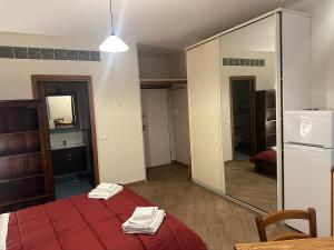 a bedroom with a red bed and a mirror at Suite Cerchio 3 - City Center in Ravenna