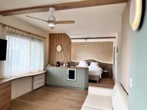 a hotel room with a bed and a television at Hôtel Beau Soleil in Pornic