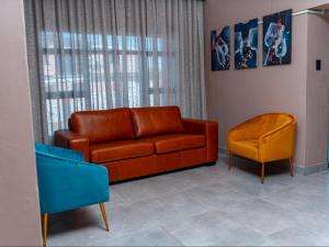 a living room with a couch and a chair at The Hill Boutique Hotel in Tsolo