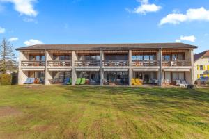 a large house with a large yard in front of it at Cari'Stay in Portalban- Dessous