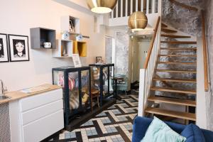 a staircase in a living room with a stair case at Hotel Steeds aan Zee in Katwijk aan Zee