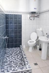 a bathroom with a toilet and a sink at Sampa Villa in Asprovalta