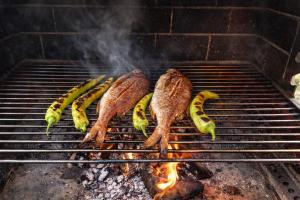 a group of food cooking on a grill at Sampa Villa in Asprovalta