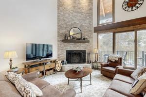 a living room with a couch and a fireplace at The Pines Condo Unit 2044 in Keystone