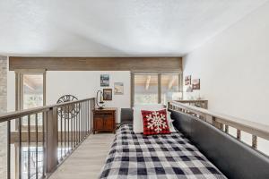 a room with a balcony with a bed and a table at The Pines Condo Unit 2044 in Keystone