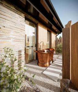 a copper tub sitting outside of a house at Aysgarth Falls Hotel & Restaurant in Aysgarth