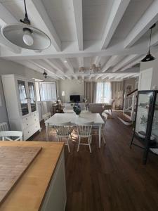 a living room with white tables and chairs at La Casa de Nueva in Nueva de Llanes
