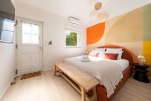 a bedroom with a bed and a wooden bench at Air Nomad • Séville in Valenciennes