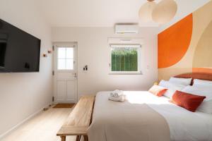 a bedroom with a large bed and a television at Air Nomad • Séville in Valenciennes