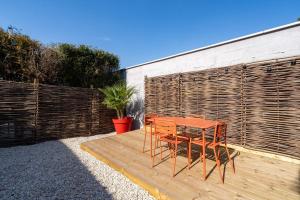 a table and two chairs sitting on a wooden deck at Air Nomad • Séville in Valenciennes