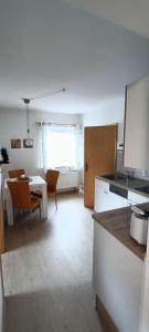 a kitchen and living room with a table and chairs at Ferienwohnung Tschitschmann in Naumburg +8 photos