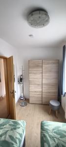 a bedroom with two beds and a dresser and a lamp at Ferienwohnung Tschitschmann in Naumburg