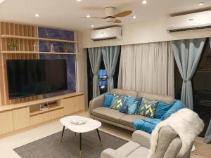 a living room with a couch and a flat screen tv at Luxury Villa by Andres in San Juan