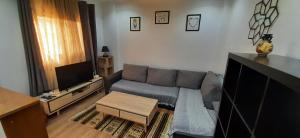 a living room with a couch and a tv at Alger Draria f2 in Alger