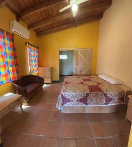 a bedroom with a bed and a chair in a room at Las Casitas de La Bahia Calechosa in Emiliano Zapata +35 photos