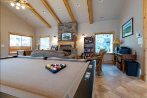 a living room with a pool table at Lakeside Funscape LS33 Ski & Snowboard Hot Tub in Huntsville