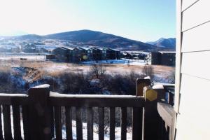 a bench with a view of a city with snow at Lakeside Funscape LS33 Ski & Snowboard Hot Tub in Huntsville +48 photos