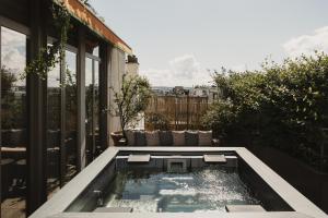 a small swimming pool on the roof of a house at Brach Paris - Evok Collection in Paris