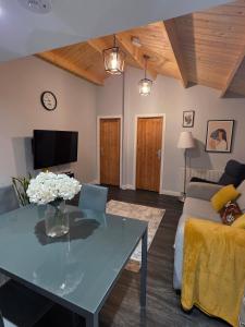a living room with a table and a couch at Secluded Log Cabin escape in High Wycombe