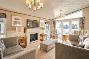 a living room with a couch and a fireplace at Lakeside Gem with Hot Tub in York
