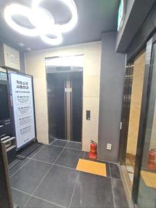 a hallway of a building with a door and a sign at Regen Hotel in Seoul
