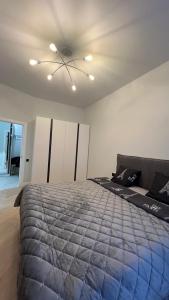 a bedroom with a bed and a ceiling fan at Квартира подобово класу "ЛЮКС" in Khmelnytskyi