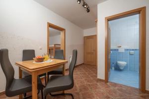 a dining room with a table and chairs and a toilet at Rooms & Apartments Pr Matjon in Bled +65 photos