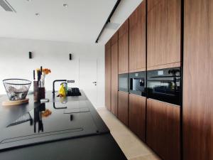 a kitchen with a counter and wooden cabinets at Villa Lippia in Misraħ Miel