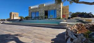 a building with a car parked in front of it at Villa Lippia in Misraħ Miel