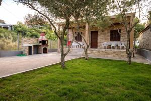 a house with a brick oven in a yard at Sampa Villa in Asprovalta +4 photos