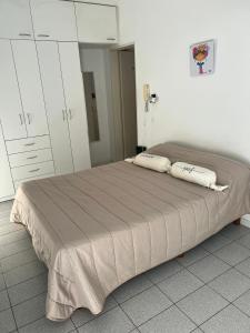 a bedroom with a bed with two pillows on it at Monoambiente Supercéntrico! San Martín 436 in Tandil +15 photos