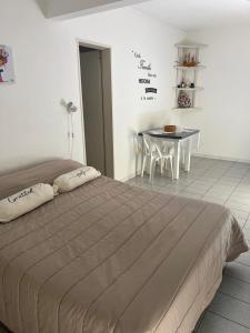 a bedroom with a bed and a table with chairs at Monoambiente Supercéntrico! San Martín 436 in Tandil