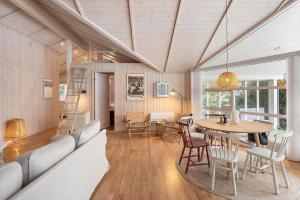 a living room with a table and chairs at M402-Vaeggerlose-Stolt-Henriksvej-93 in Bøtø By
