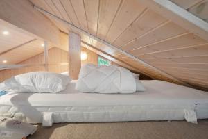 a bed with white pillows in a room at M402-Vaeggerlose-Stolt-Henriksvej-93 in Bøtø By