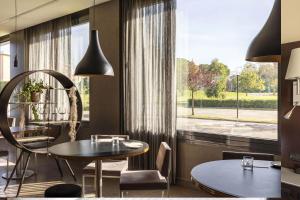 a dining room with a table and a window at B&B Hotel Arezzo in Arezzo