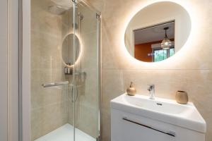 a bathroom with a sink and a shower with a mirror at Air Nomad • Marrakech in Valenciennes