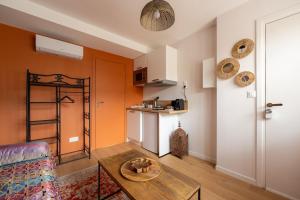 a living room with a couch and a table at Air Nomad • Marrakech in Valenciennes