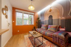 a living room with a couch and a table at Air Nomad • Marrakech in Valenciennes