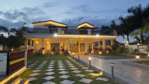 ein Haus mit einem Schachbrettmusterboden davor in der Unterkunft Kurunchi Malar Resorts in Hosur