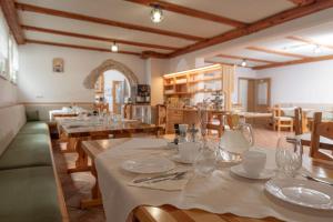 a dining room with wooden tables and chairs and a room with tablesktop at Rooms & Apartments Pr Matjon in Bled